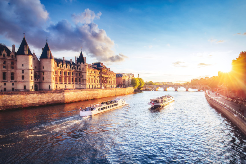 Dramatic sunset over Cite in Paris, France, with Conciergerie, P